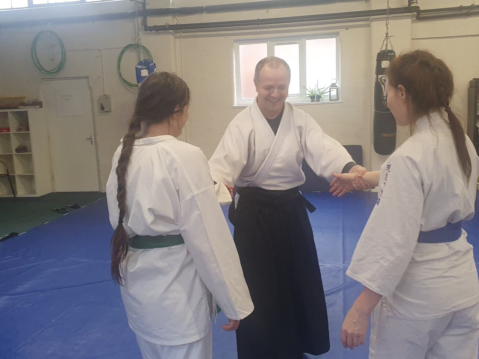 Close detail of an Aikido technique between two adult students